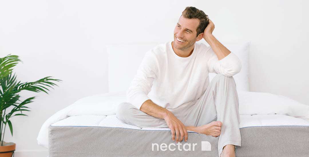 Man Sitting on Nectar Bed