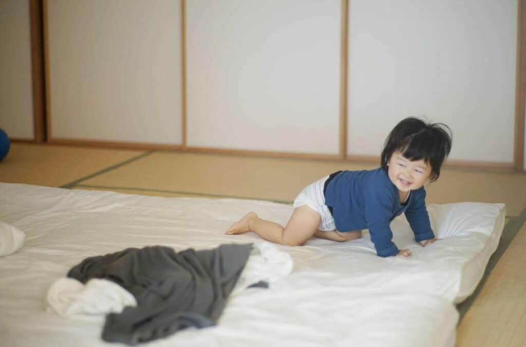 A Baby Playing on the Floor
