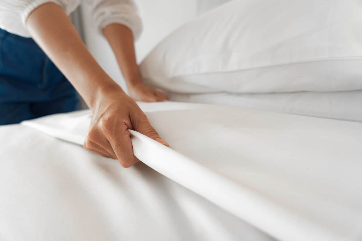 Female Hand set up white bed sheet