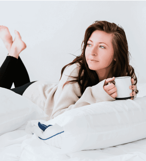 young woman relaxing with coffee on nectar mattress and nectar pillow