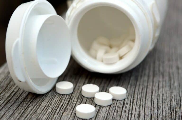 Melatonin pill box with white pills