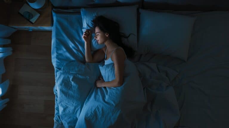 A young women dreaming while sleeping cozily in bed