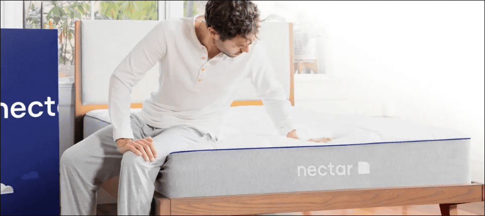 guy sitting on nectar mattress