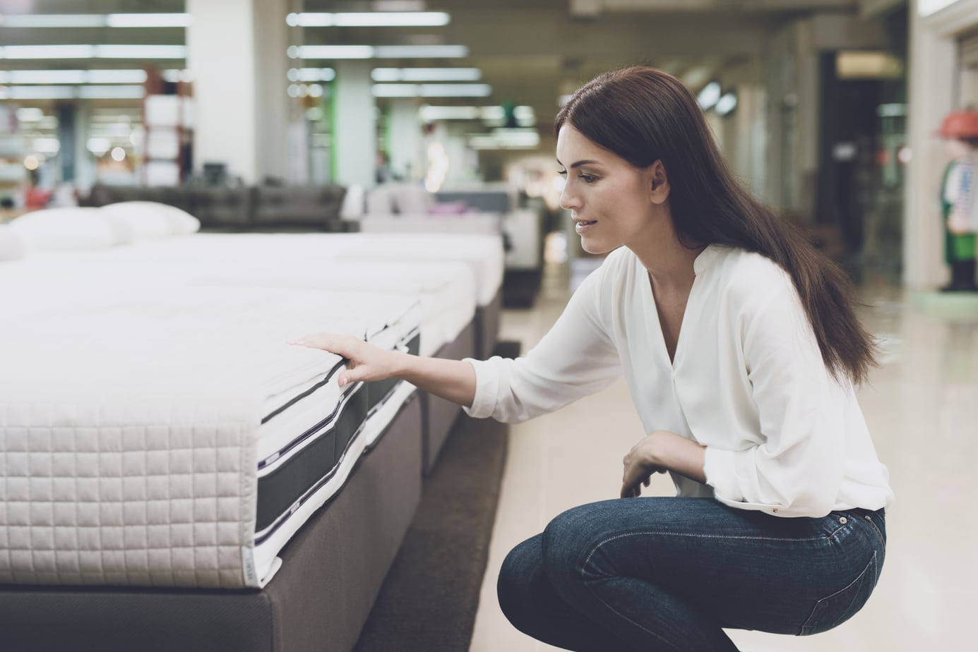 Woman Chooses A Mattress