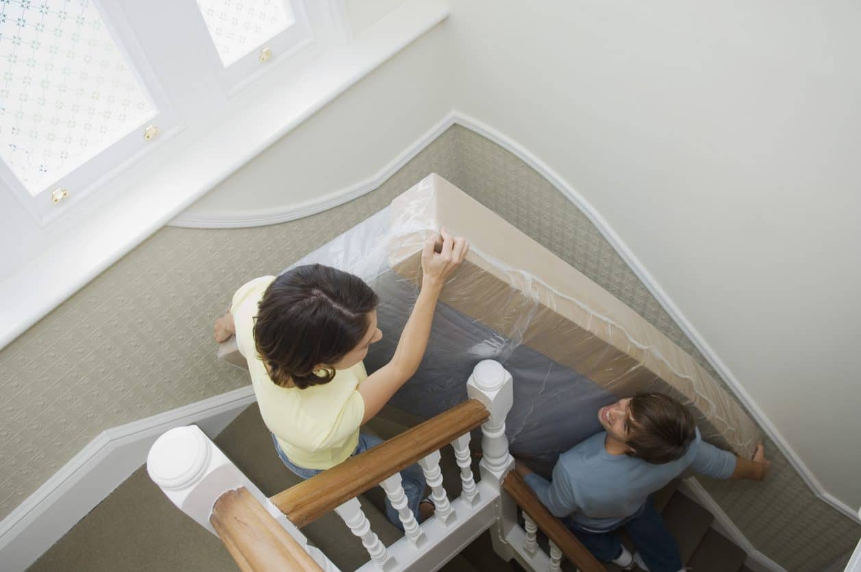 people moving a mattress