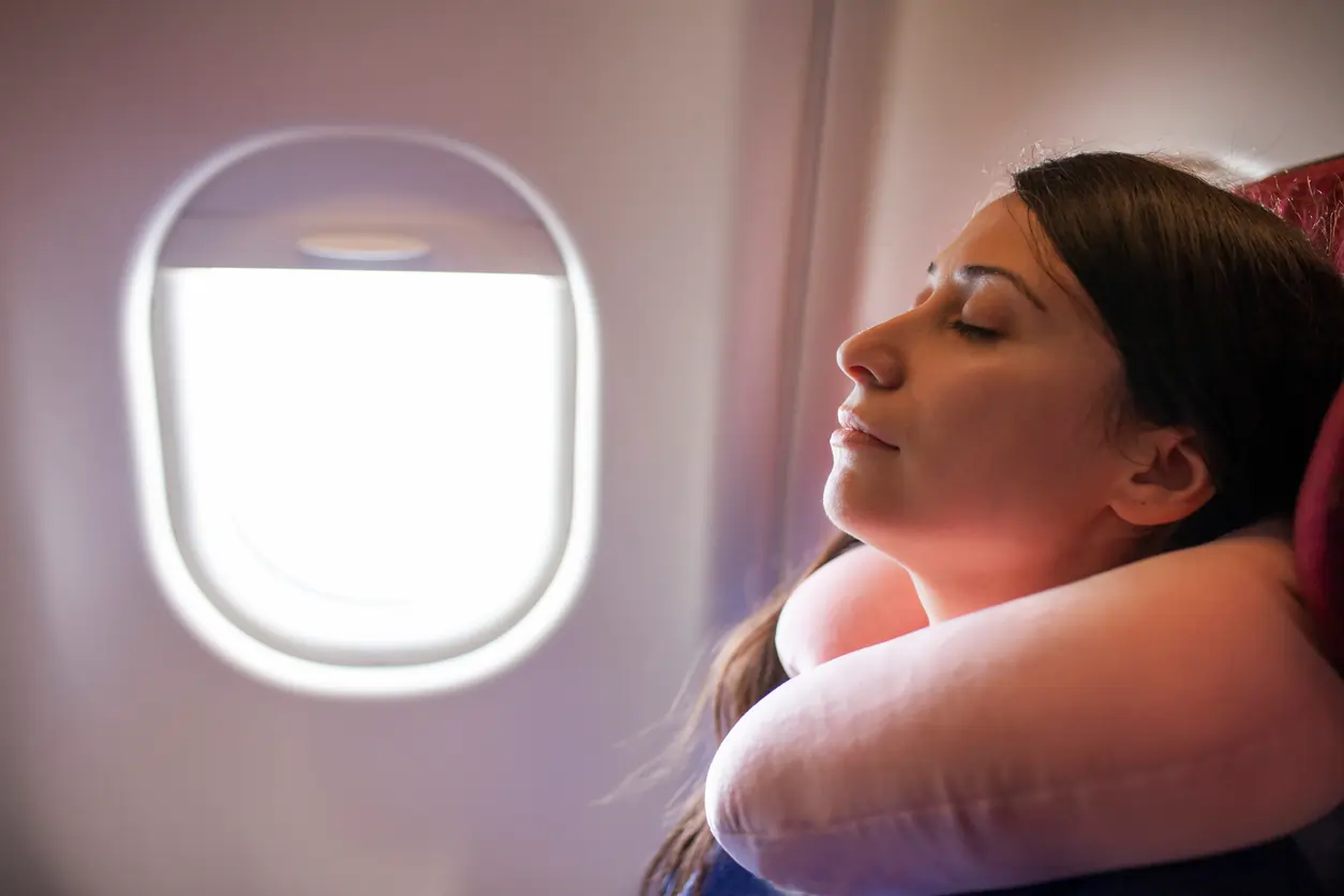 women sleeping on plane